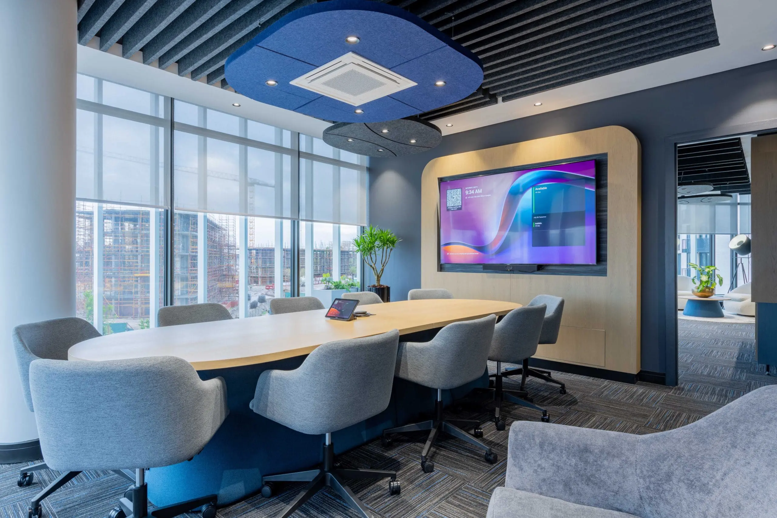 ceo executive meeting room with acoustic baffles and wall unit with screen